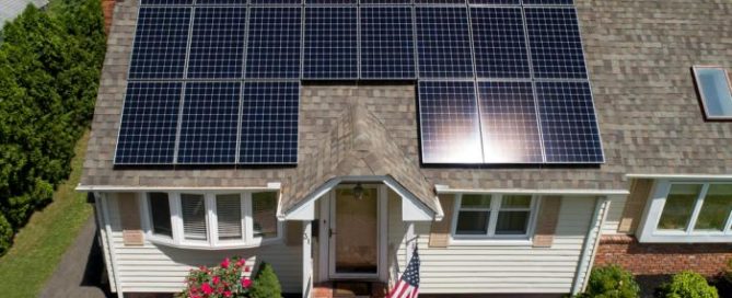 Residential home with solar panels installed by Synergy 768, showcasing energy-efficient roofing and solar solutions.