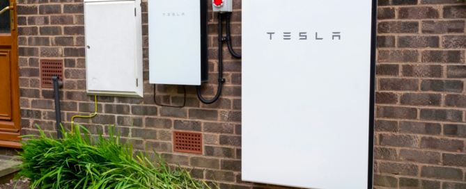 Tesla Powerwall and other electrical components installed on a brick wall